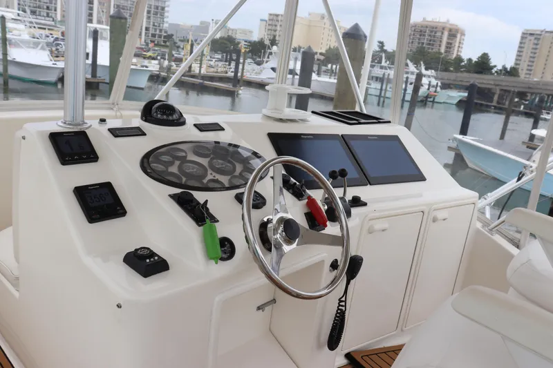 Slide: The Image of 2004 Ocean Yachts 43 Super Sport helm with navigation controls and marina view. - 12