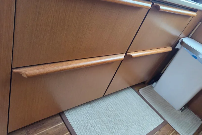 Slide: The Image of Wooden cabinetry and trash bin in 2004 Ocean Yachts 43 Super Sport interior. - 18