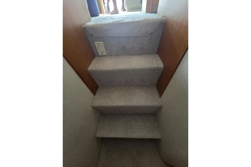 Slide: The Image of Carpeted stairs inside 2004 Ocean Yachts 43 Super Sport boat. - 19