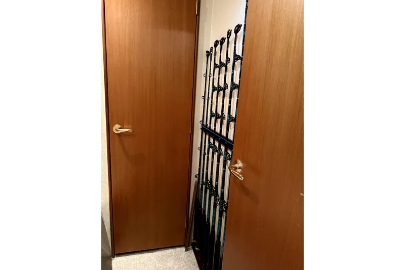 Slide: The Image of Wooden door with fishing rods storage on a 2004 Ocean Yachts 43 Super Sport. - 31