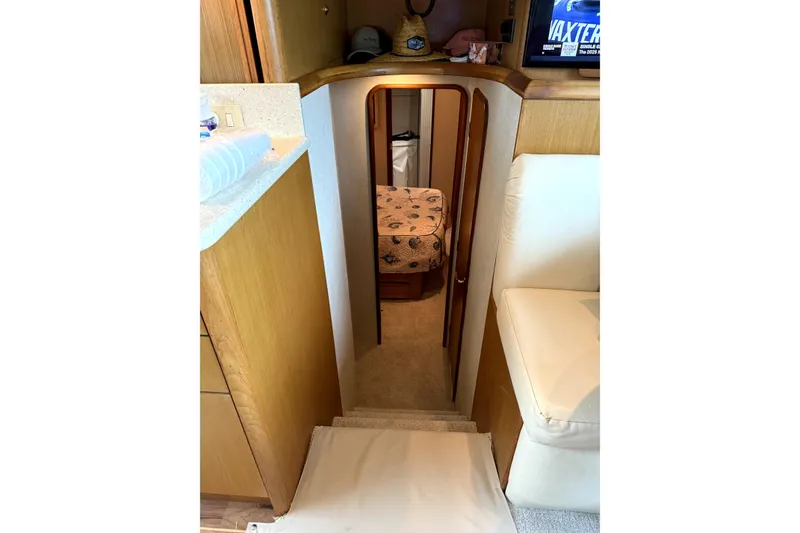 Slide: The Image of Interior view of 2004 Ocean Yachts 43 Super Sport, featuring cozy cabin and wooden cabinetry. - 32