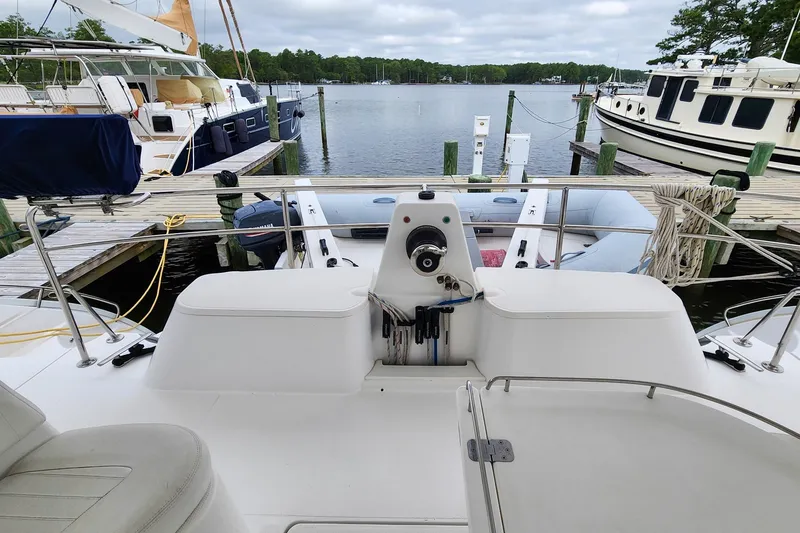 Slide: The Image of 2019 Antares 44GT yacht docked at marina, featuring spacious deck and serene water view. - 11