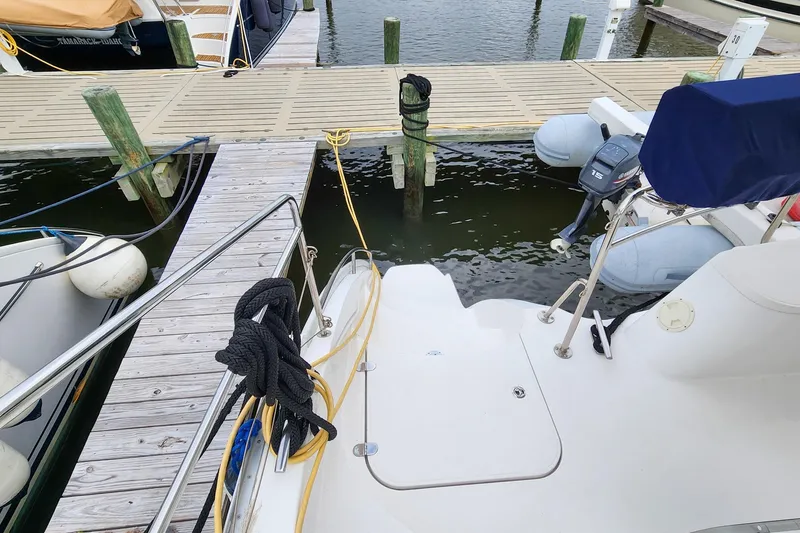 Slide: The Image of Docked Antares 44GT yacht with outboard motor, 2019 model, at a marina. - 16
