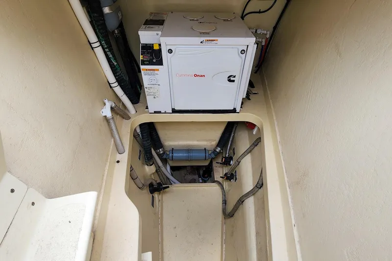 Slide: The Image of Engine compartment of 2019 Antares 44GT with Cummins Onan generator and visible piping. - 24