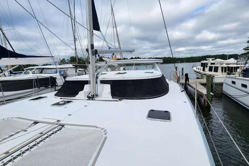 Slide: The Image of 2019 Antares 44GT yacht docked at marina, surrounded by other boats. - 3