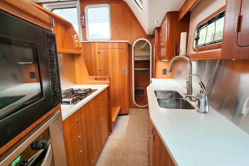 Slide: The Image of Luxurious 2019 Antares 44GT yacht kitchen with modern appliances and sleek wood cabinetry. - 35