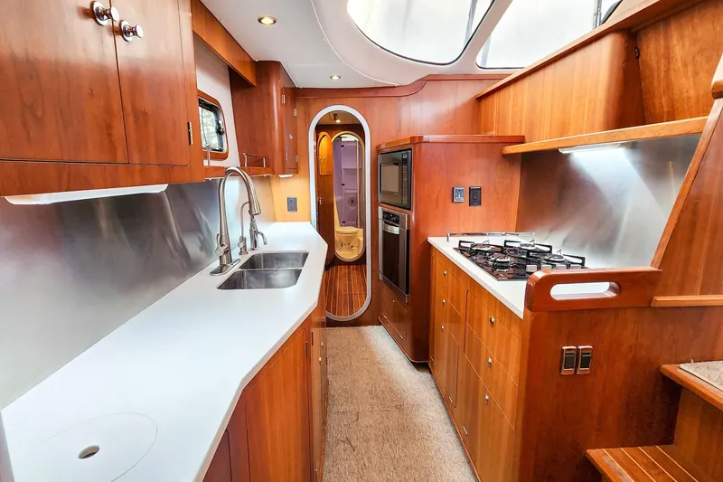 Slide: The Image of Luxurious 2019 Antares 44GT yacht kitchen with wood cabinetry and modern appliances. - 36