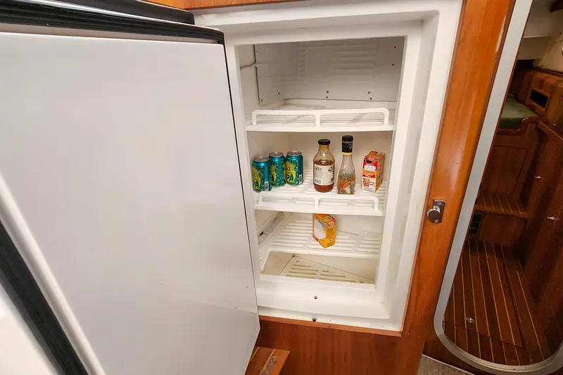 Slide: The Image of Open refrigerator in 2019 Antares 44GT yacht with drinks and condiments inside. - 38