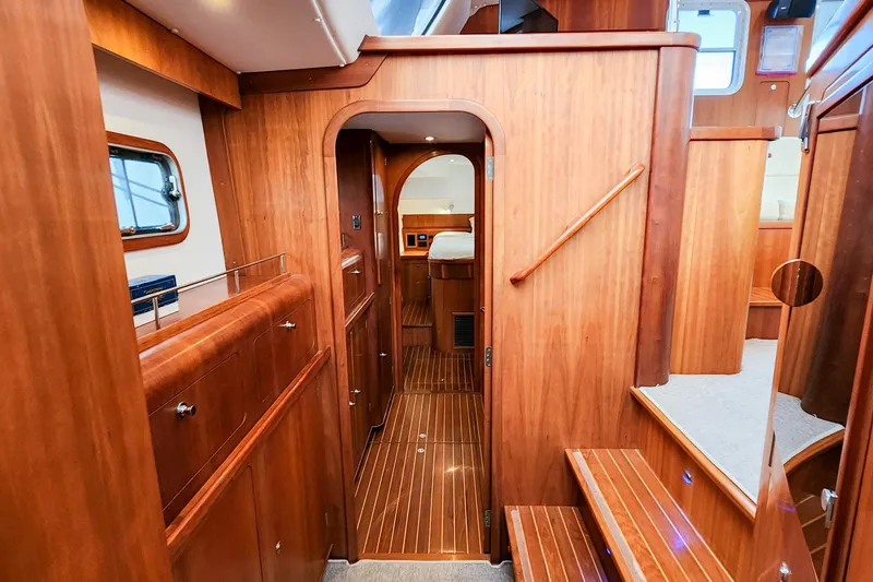 Slide: The Image of Luxurious wooden interior of 2019 Antares 44GT yacht, featuring elegant cabinetry and cozy cabin. - 40