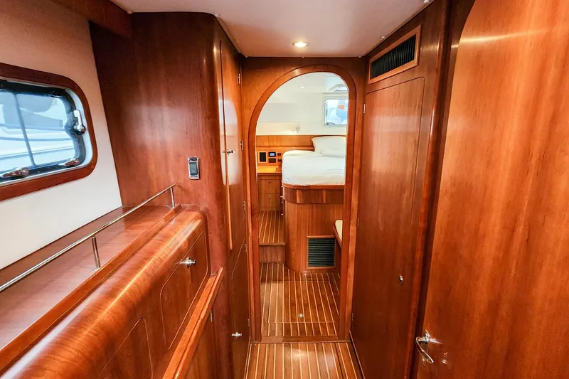 Slide: The Image of Luxurious wooden interior of 2019 Antares 44GT yacht cabin with bed and window. - 41