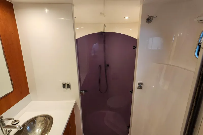 Slide: The Image of 2019 Antares 44GT yacht bathroom with purple shower, modern sink, and sleek design. - 45