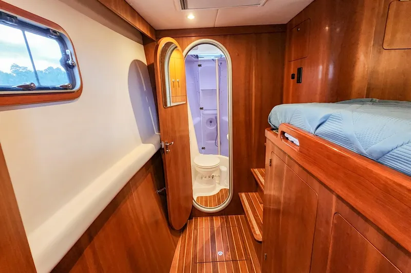 Slide: The Image of Luxurious 2019 Antares 44GT yacht interior with wooden finish and compact bathroom. - 48
