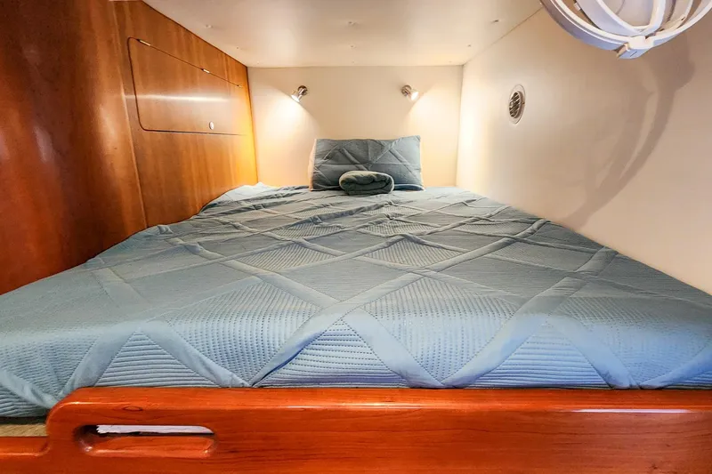 Slide: The Image of Cozy cabin bed in 2019 Antares 44GT yacht with wooden accents and soft lighting. - 49
