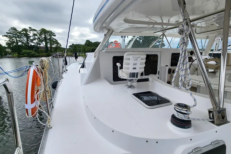 Slide: The Image of 2019 Antares 44GT yacht deck with seating, ropes, and life preserver by a calm river. - 5