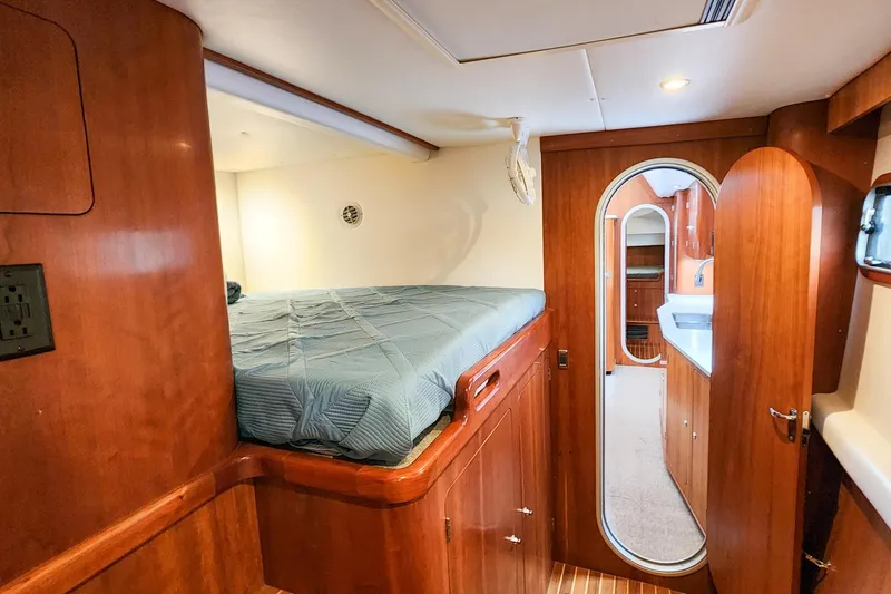 Slide: The Image of Cozy cabin interior of 2019 Antares 44GT yacht with wooden finish and bed. - 50