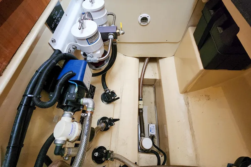 Slide: The Image of Engine compartment of 2019 Antares 44GT yacht, showcasing mechanical components and piping. - 52