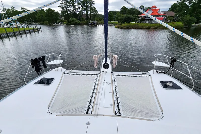 Slide: The Image of Front deck of 2019 Antares 44GT catamaran on a serene river. - 6