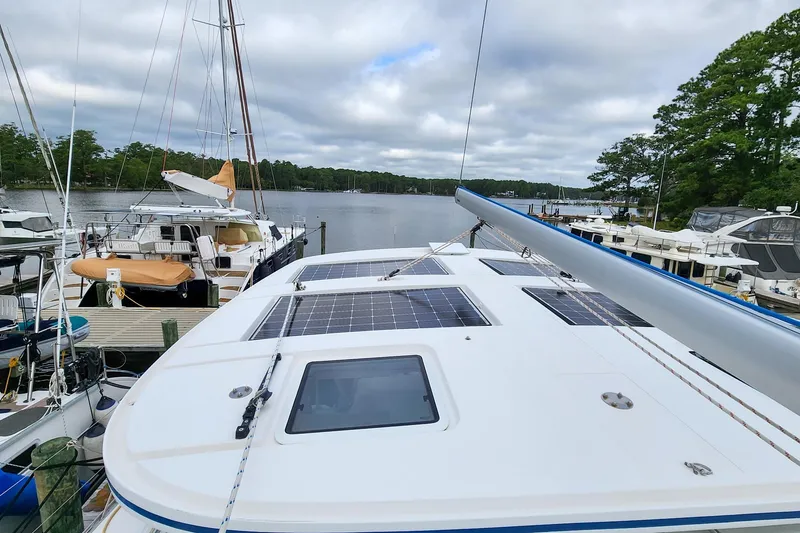 Slide: The Image of Sailboat Antares 44GT 2019 docked, featuring solar panels on deck, surrounded by other boats. - 9