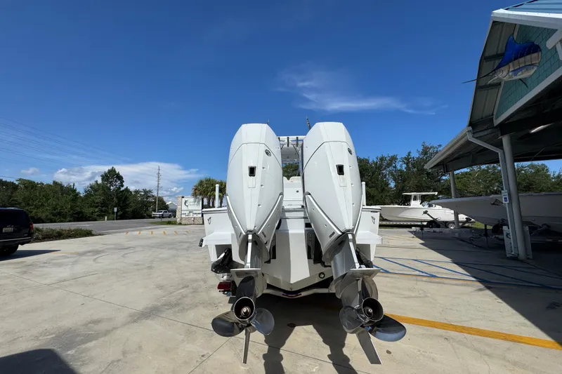 Slide: The Image of 2025 Conch 33 boat with dual outboard motors in a sunny outdoor setting. - 16