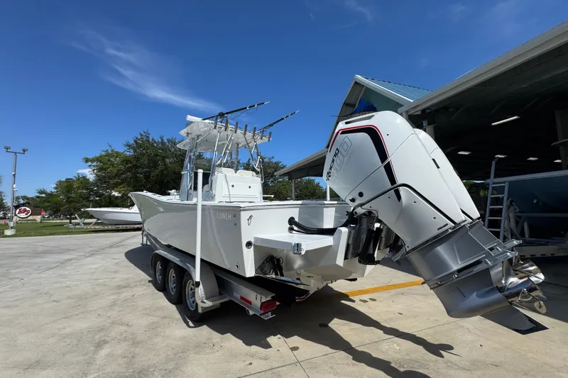 Slide: The Image of 2025 Conch 33 boat with powerful outboard engine on a trailer. - 18