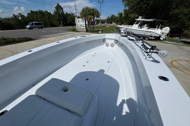 Slide: The Image of 2025 Conch 33 boat interior with seating and equipment, parked outdoors. - 20