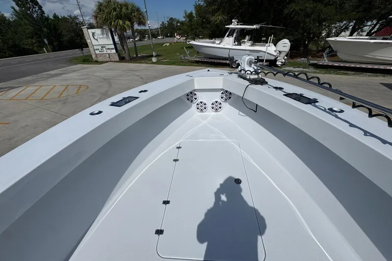 Slide: The Image of 2025 Conch 33 boat deck with speakers and equipment, parked outdoors. - 21