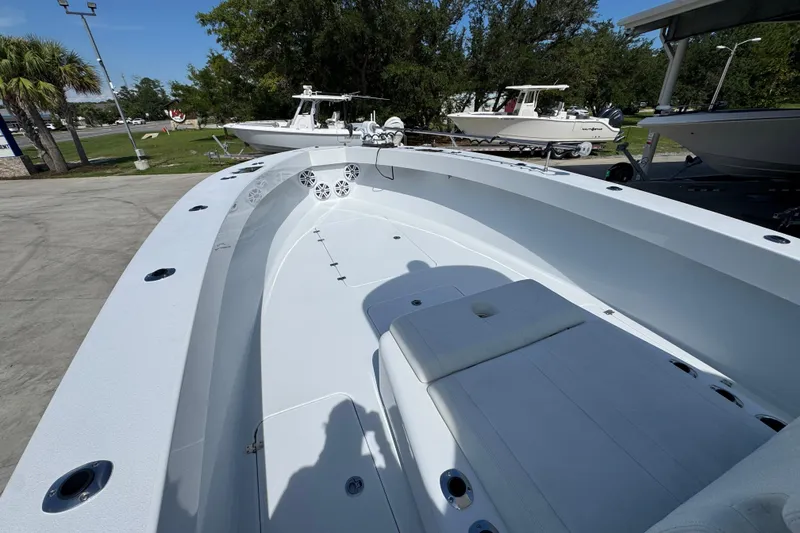 Slide: The Image of 2025 Conch 33 boat with spacious deck and seating, parked outdoors. - 22