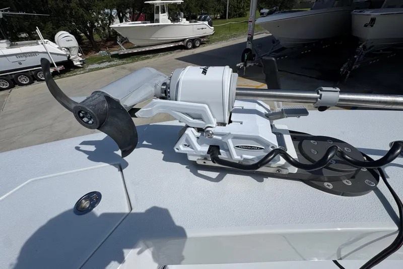 Slide: The Image of Trolling motor mounted on a 2025 Conch 33 boat, with other boats in the background. - 23
