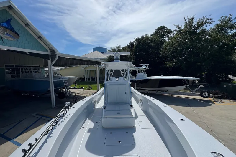 Slide: The Image of 2025 Conch 33 boat displayed outdoors at a marina, surrounded by other boats. - 25