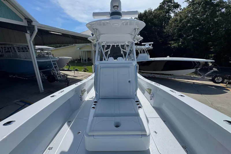 Slide: The Image of 2025 Conch 33 boat with sleek design, docked outdoors under clear sky. - 26