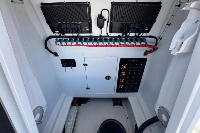Slide: The Image of Electrical panel of 2025 Conch 33 boat with Garmin systems and organized wiring. - 27