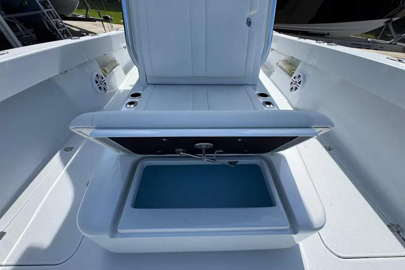 Slide: The Image of 2025 Conch 33 boat interior with open storage compartment and speakers. - 28