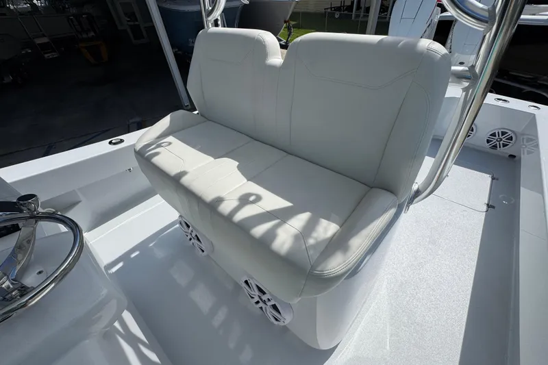 Slide: The Image of White seating on 2025 Conch 33 boat, featuring sleek design and integrated speakers. - 31