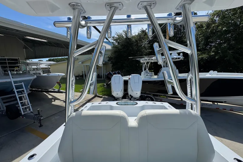 Slide: The Image of 2025 Conch 33 boat with dual engines and sleek design in a marina setting. - 33