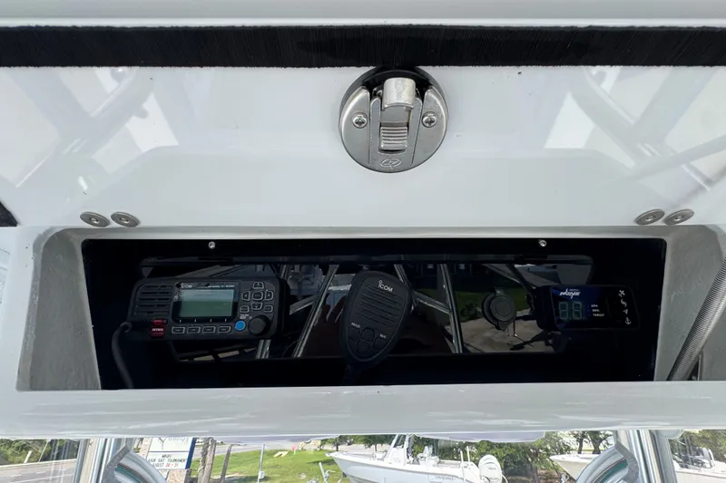 Slide: The Image of 2025 Conch 33 boat dashboard with communication equipment and controls. - 38