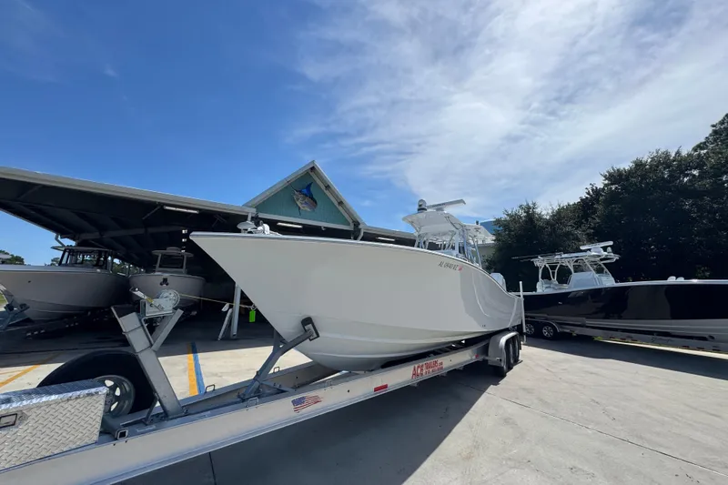 Slide: The Image of 2025 Conch 33 boat on trailer under clear blue sky. - 5