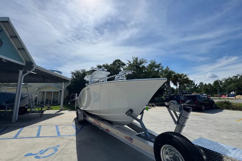 Slide: The Image of 2025 Conch 33 boat on trailer under clear sky, parked outdoors. - 8