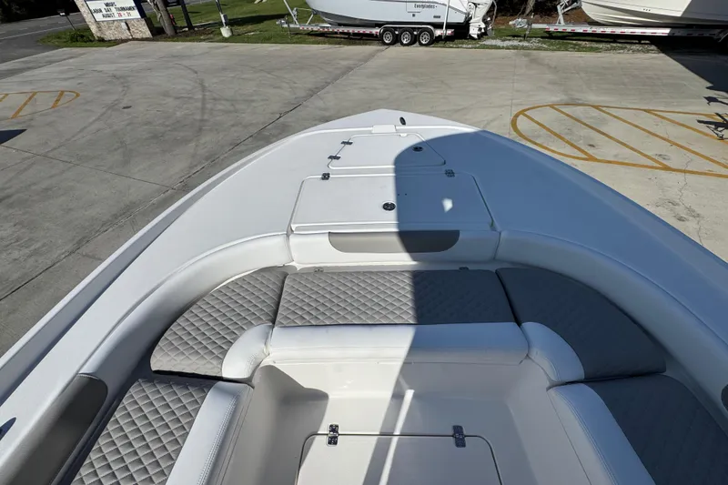 Slide: The Image of 2026 Caymas 24 HB boat interior with cushioned seating and storage compartments. - 19