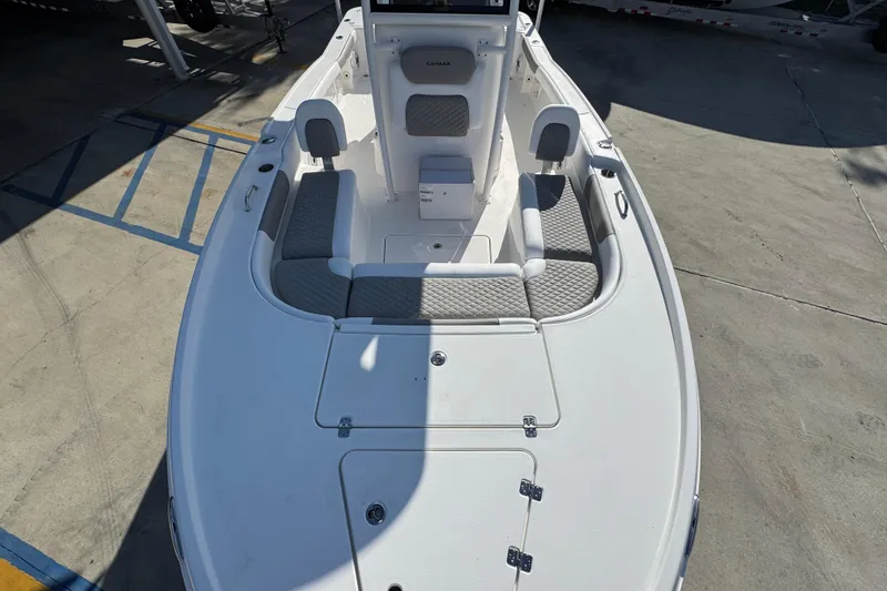 Slide: The Image of 2026 Caymas 24 HB boat interior with gray seating and storage compartments. - 21