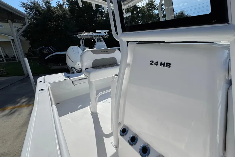 Slide: The Image of 2026 Caymas 24 HB boat interior with seating and console details. - 25