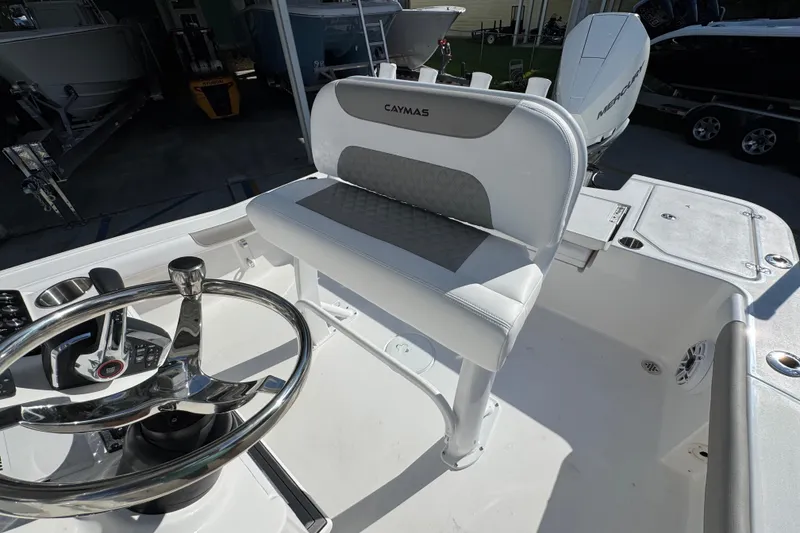 Slide: The Image of 2026 Caymas 24 HB boat interior with steering wheel and seating. - 27