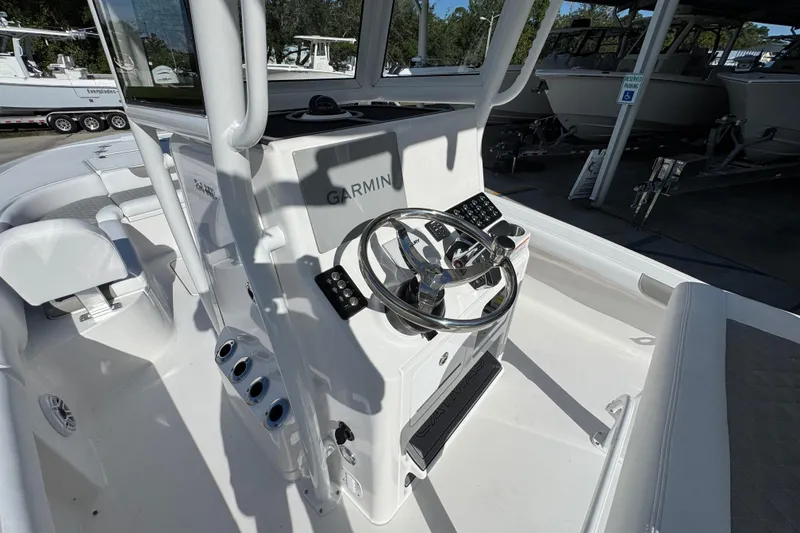 Slide: The Image of 2026 Caymas 24 HB boat cockpit with Garmin navigation system and sleek steering wheel. - 29