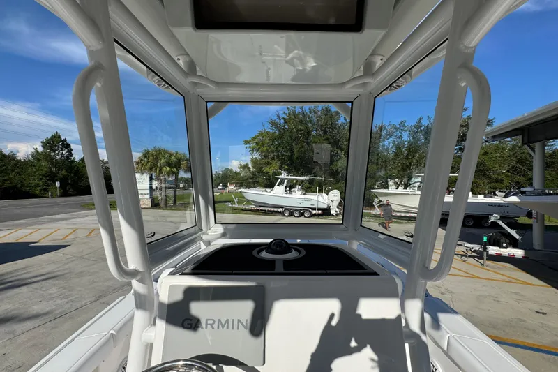 Slide: The Image of 2026 Caymas 24 HB boat interior with Garmin navigation, docked outdoors. - 31
