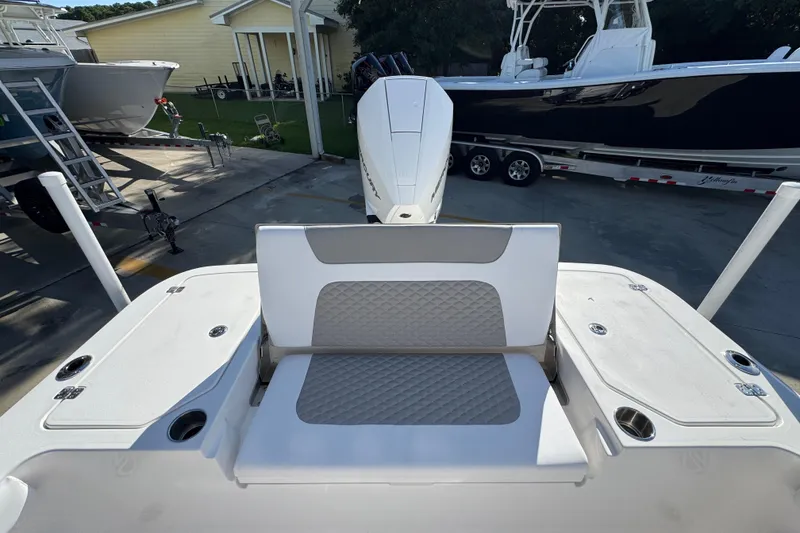 Slide: The Image of 2026 Caymas 24 HB boat interior with cushioned seating and storage compartments. - 36