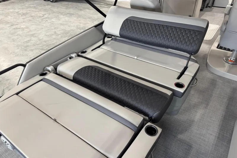 Slide: The Image of 2026 Sylvan L-5 boat interior with gray and black cushioned seating and cup holders. - 12