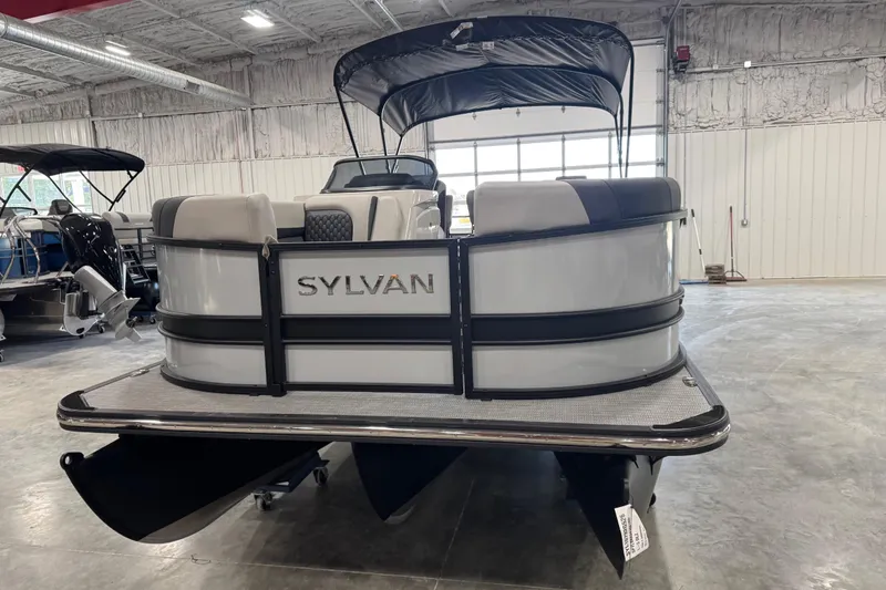 Slide: The Image of 2026 Sylvan L-5 pontoon boat in showroom, featuring sleek design and modern amenities. - 5