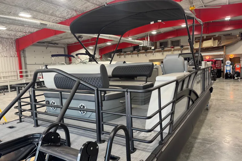 Slide: The Image of 2026 Sylvan L-5 pontoon boat in showroom, featuring sleek design and spacious seating. - 6