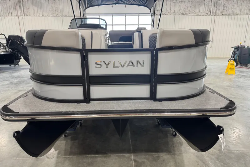 Slide: The Image of 2026 Sylvan L-5 pontoon boat in a showroom, rear view. - 7