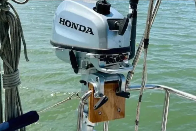 Slide: The Image of Honda outboard motor mounted on a 2007 Hanse 400 sailboat, with water in the background. - 10
