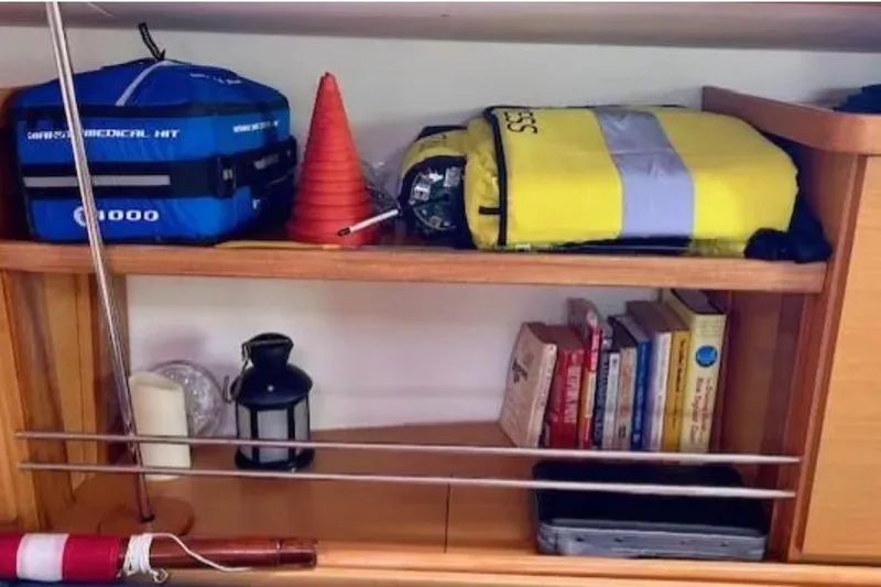 Slide: The Image of Shelf on 2007 Hanse 400 yacht with safety gear, books, and lantern. - 18